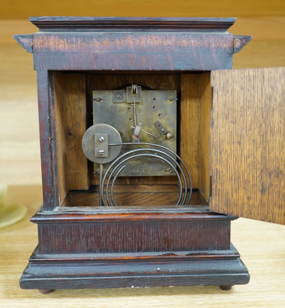 A late Victorian oak eight day mantel clock, striking on a coiled gong, height 26.5cm. Condition - fair, wear and oxidisation to dial.